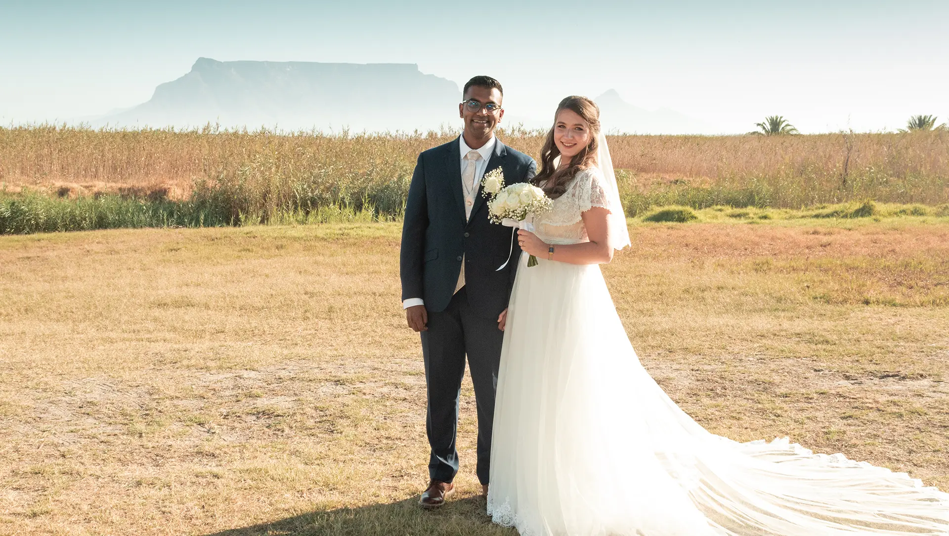 Bride and groom on the vlei with Table Mountain behind